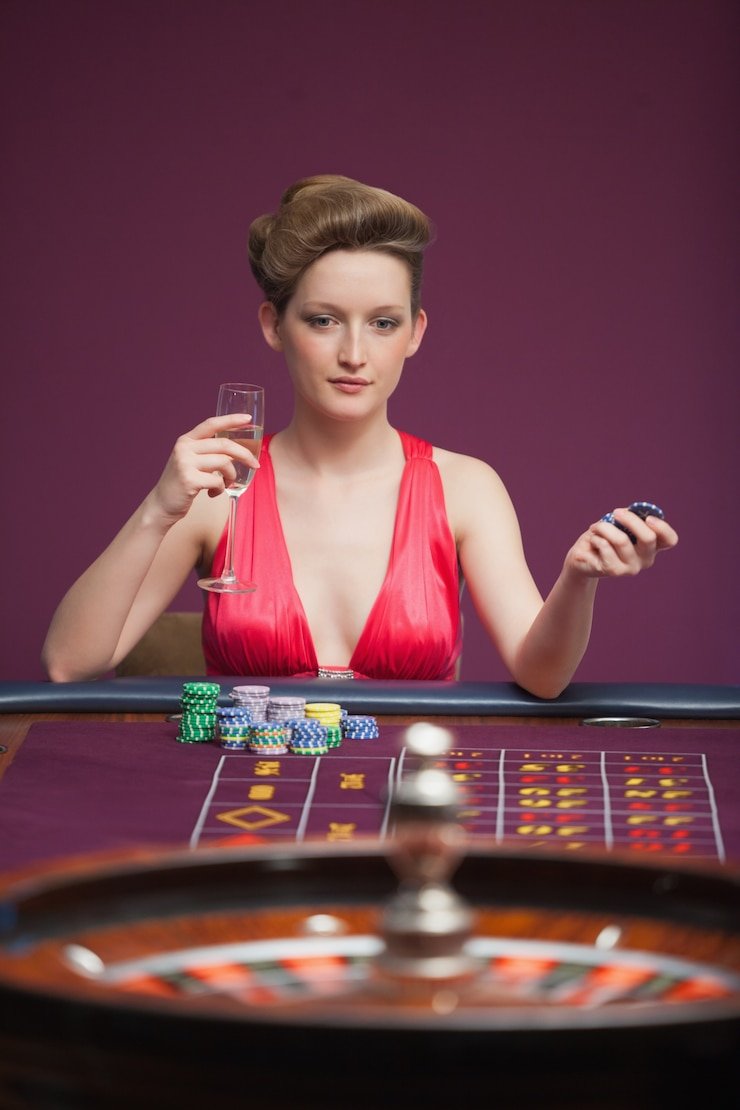 Live dealer rolling three dice in Super Sic Bo studio